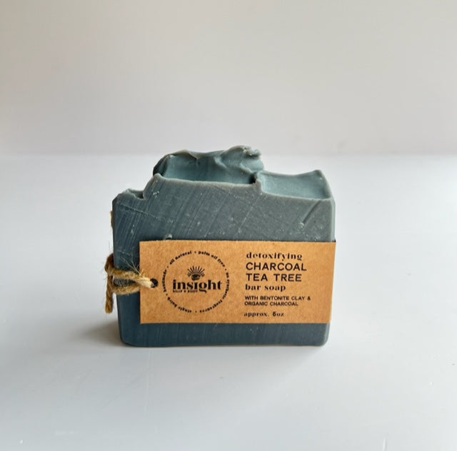 bar of charcoal gray soap with cardstock packaging