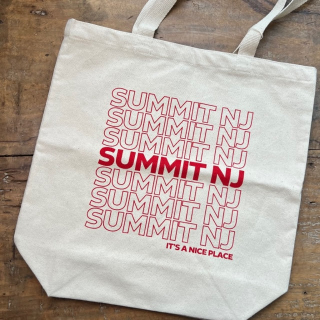 canvas tote bag that repeatedly has SUMMIT, NJ written across it in red letters. Under SUMMIT it reads It's a Nice Place.