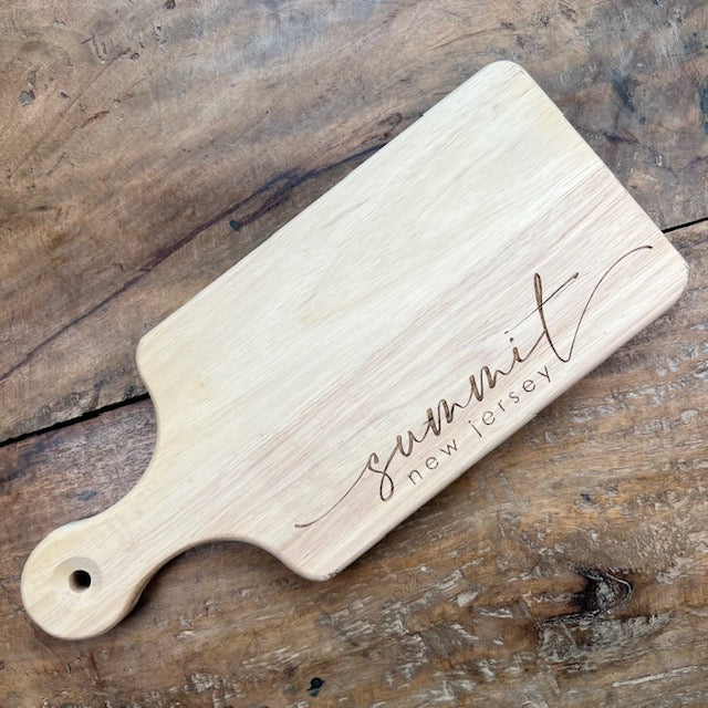 Rectangular cutting board with a handle that reads "Summit, New Jersey" 