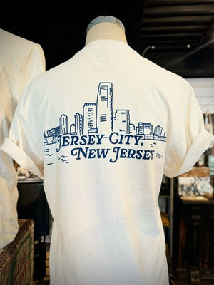 Back of the white tee shirt has an outline of the city skyline and reads Jersey City New Jersey below it.