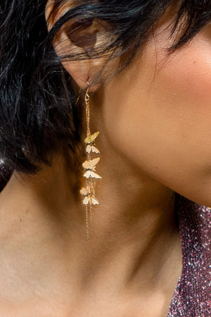 single earring in ear, showing 3 gold butterflies and gold strands danging