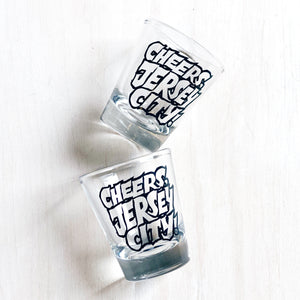 two glass shot glasses that read Cheers, Jersey City!